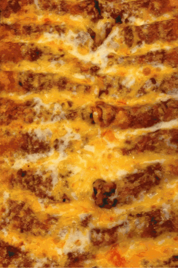 alternating images of lasagna. one is shot from above and upclose. the other is shot from the front as a hand scoops a piece out of the pan. there is meted cheese oozing from the piece being scooped.